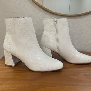 Ankle booties with white snake skin print.